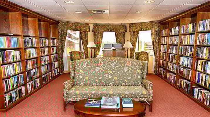 A cozy library area with bookshelves and seating