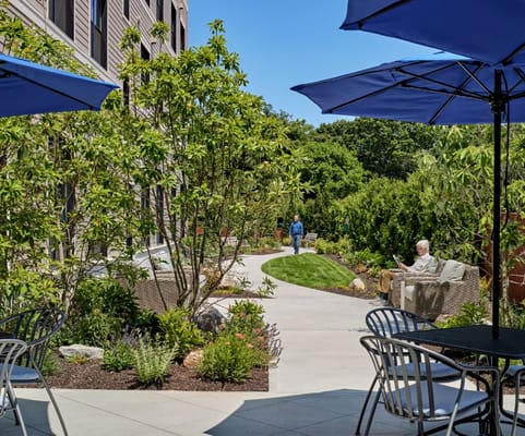 Residents enjoying the garden area under umbrellas