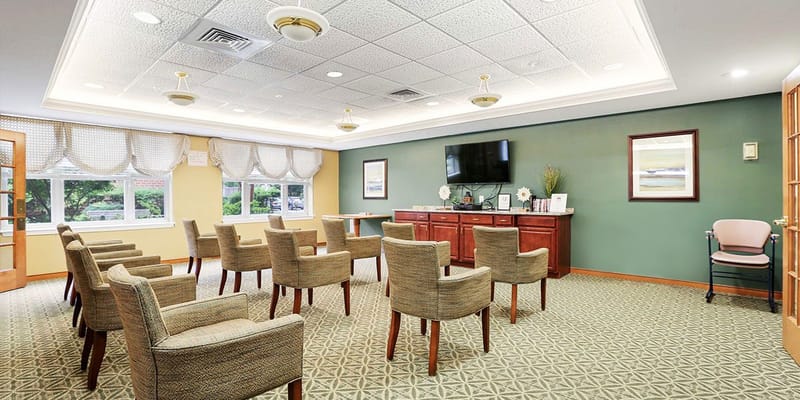 Bright activity room with seating arranged for a meeting