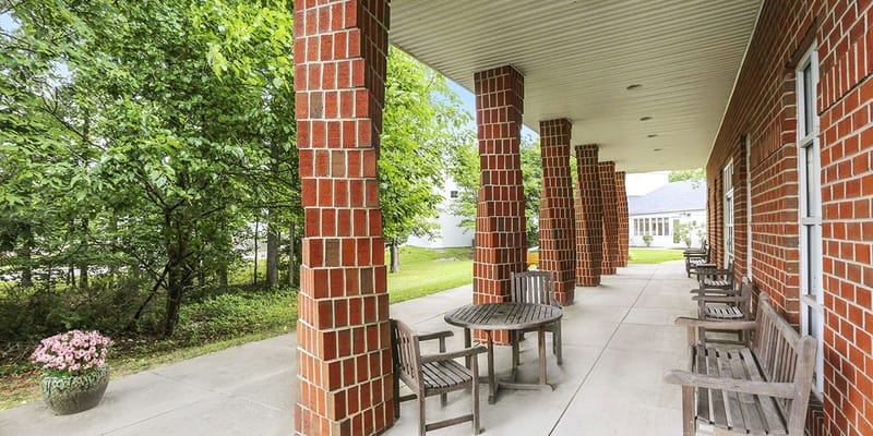 Patio area with wooden tables and chairs