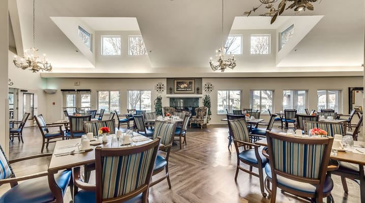 Elegant dining room with tables set for meals and large windows