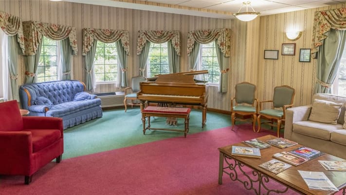 Cozy lounge area with a piano and comfortable seating