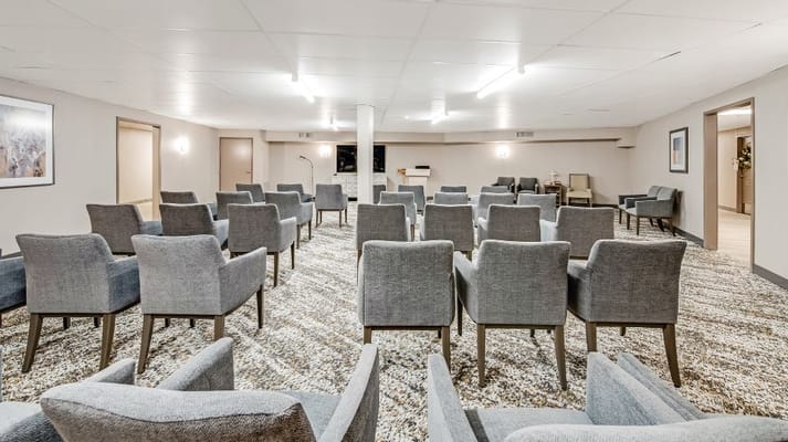 Spacious meeting room with gray chairs arranged in rows