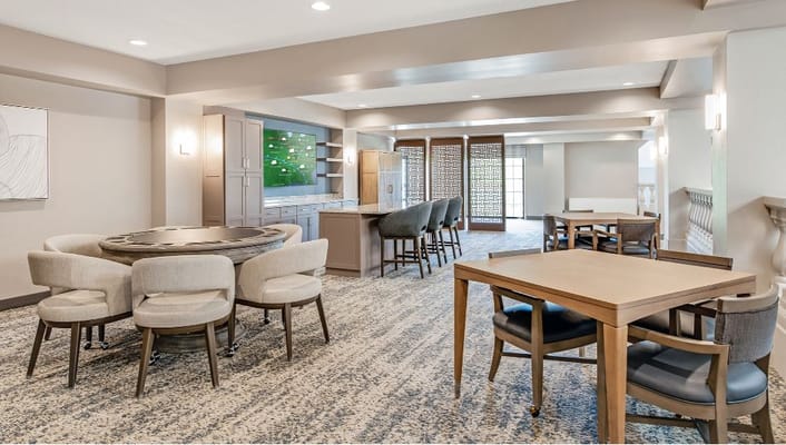 Spacious common area with tables and seating at Holiday Garden Village.