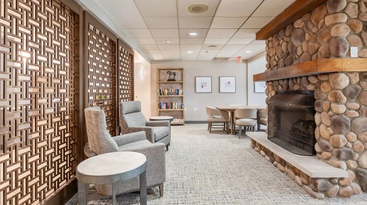 Inviting lounge area with seating and a stone fireplace