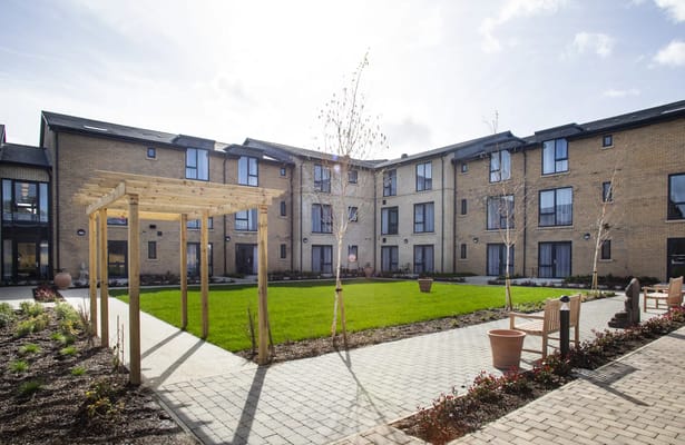 Outdoor courtyard with greenery and seating areas
