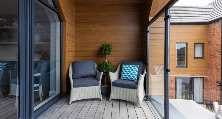 Cozy balcony space with seating and greenery