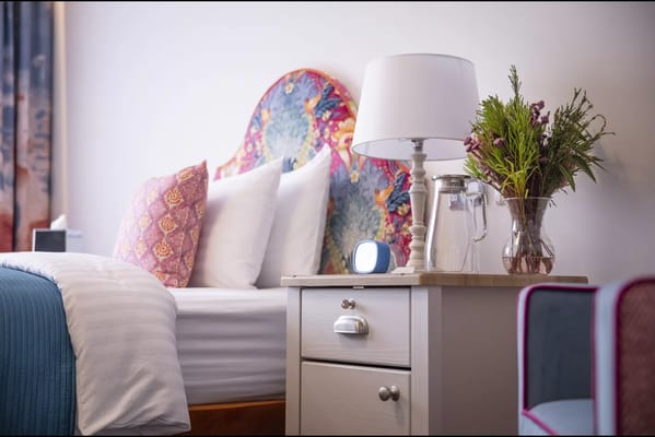 Cozy interior room with a bed and decorative lamp