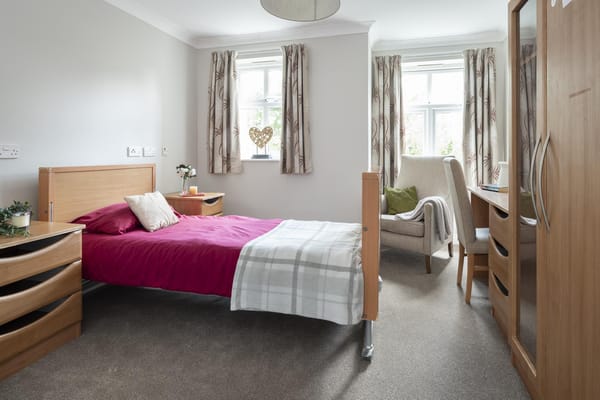 Cozy resident room with a bed and seating area