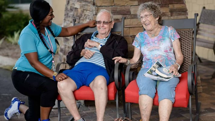A staff member chatting with residents in an outdoor space
