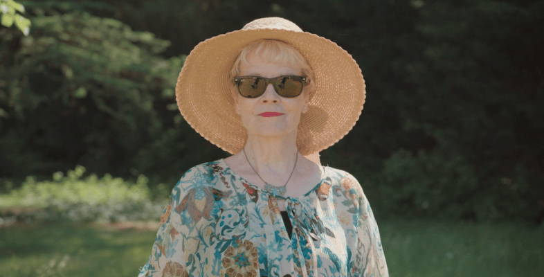 Senior woman enjoying outdoors in a sun hat