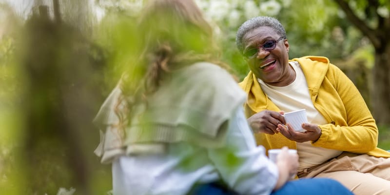 Residents enjoying tea in a garden setting