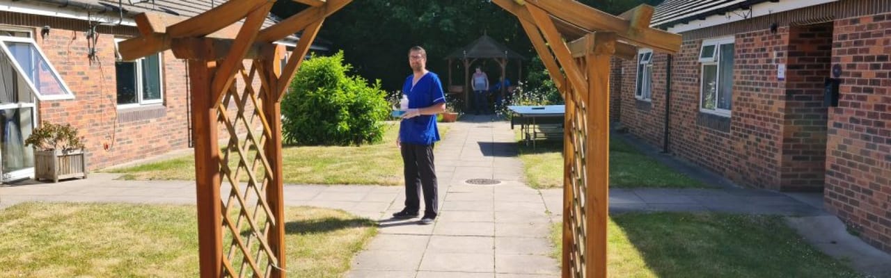 Outdoor space with a staff member and residents