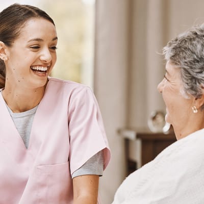 Staff member interacting with a resident in a warm setting