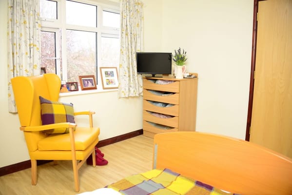 Bright interior room with a cozy chair and wood furniture