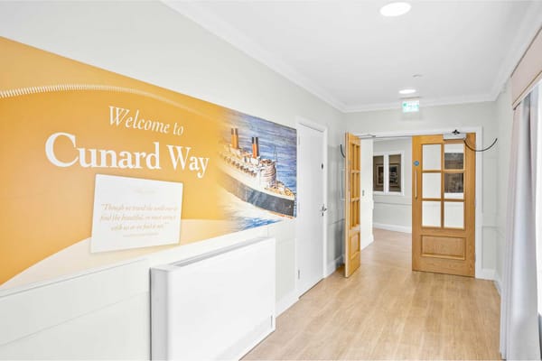 Interior corridor with a mural welcoming residents