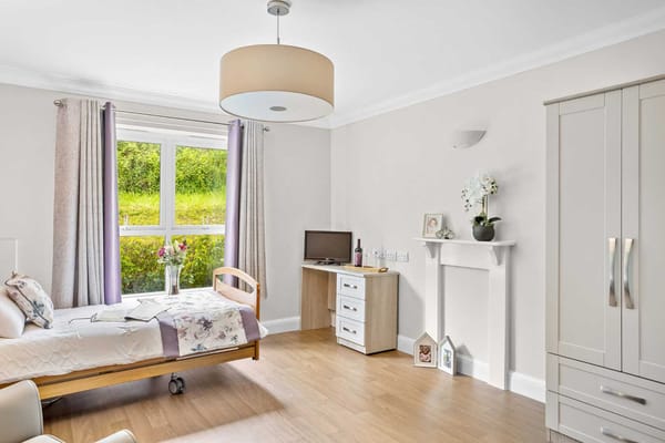 Stylish private resident room with a bed and furniture