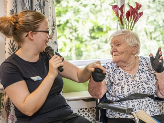 Staff member engaging with a resident in a common area