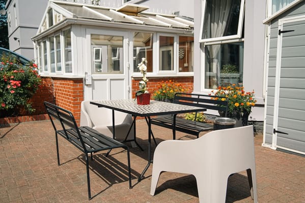 Outdoor seating area with a table and flowers