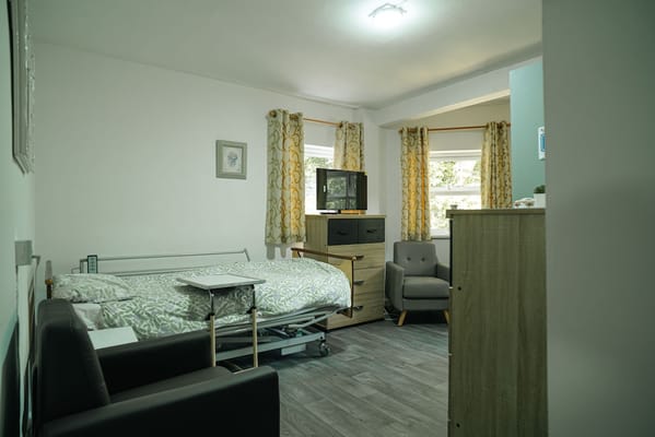 Cozy resident room with a bed and seating area