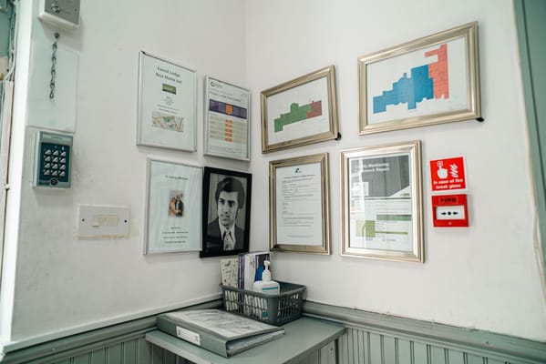 Interior corner with framed documents and a photo