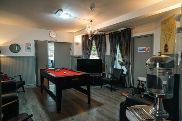 Common area with a pool table and seating