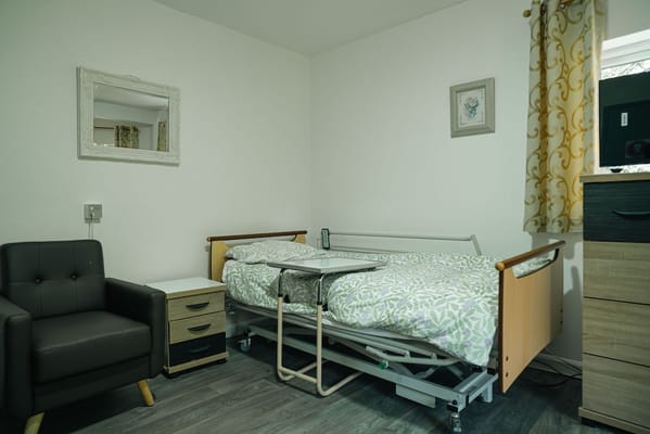 A cozy resident room with a medical bed