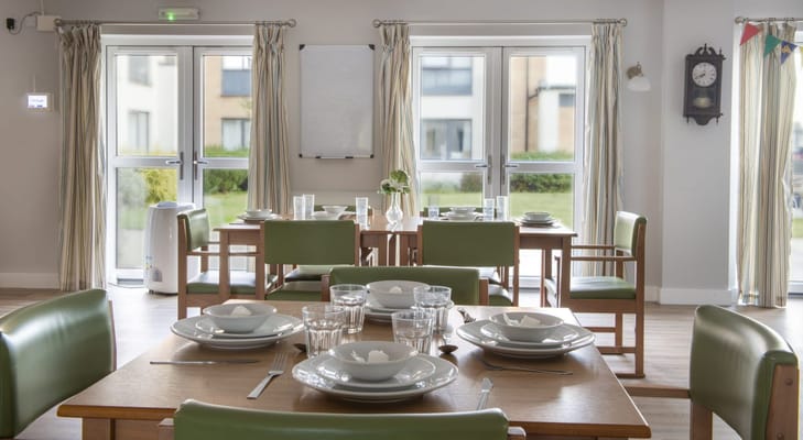 Dining area set up with plates and glasses