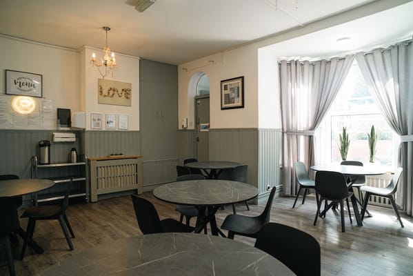 Interior view of a dining area with tables and chairs