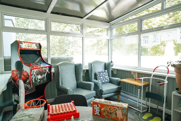Bright indoor common area with seating and games