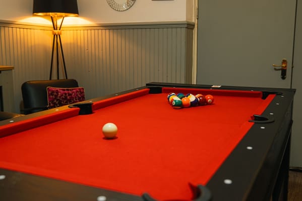 A billiards table in a recreation area