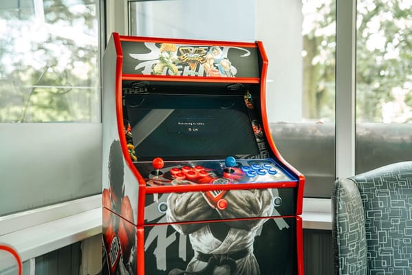 A colorful arcade game cabinet in a bright room