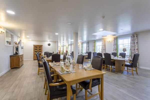 Bright dining room with tables set for meals
