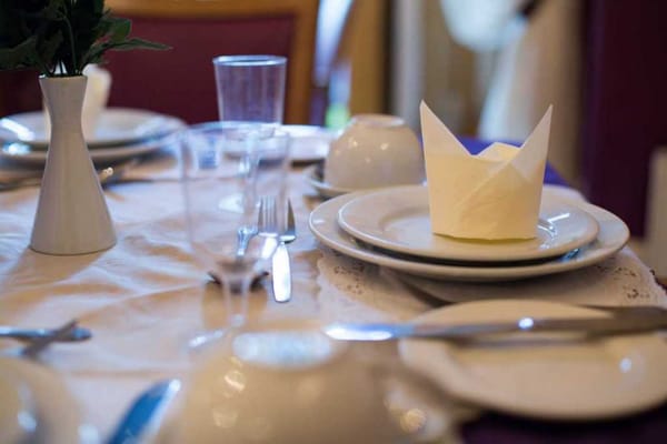Elegant dining setup with folded napkin and tableware
