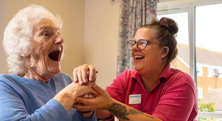 Resident joyfully engaging with staff member