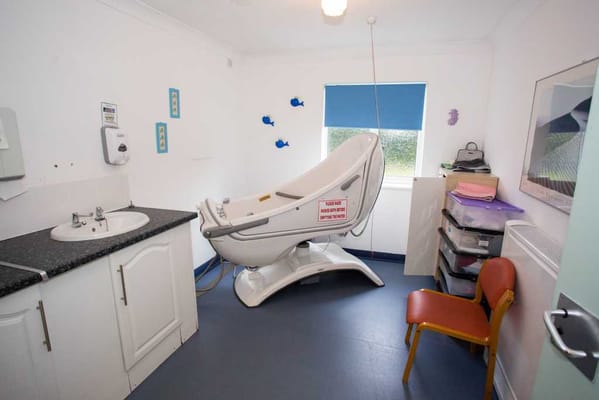Interior view of a resident room with assistive equipment