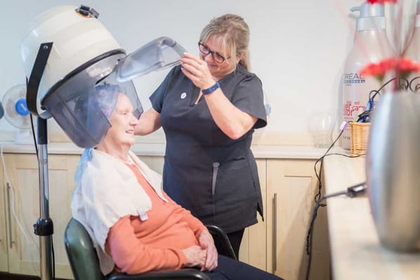 Resident enjoying a salon treatment in a care home