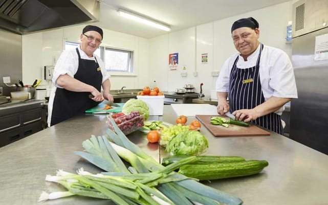 Chefs preparing fresh vegetables in the kitchen