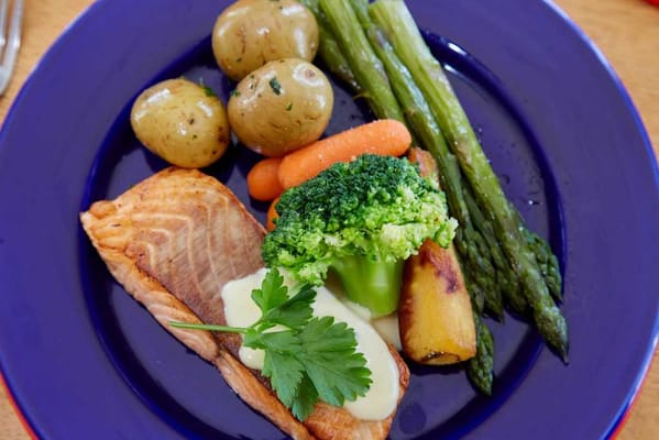 Plate of salmon with vegetables and potatoes