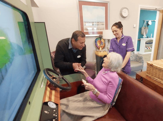Staff interacting with a resident in a cozy activity area