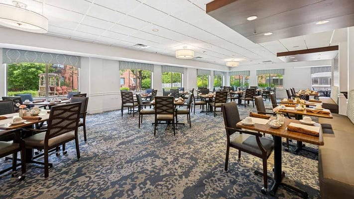 Bright dining room with tables set for meals
