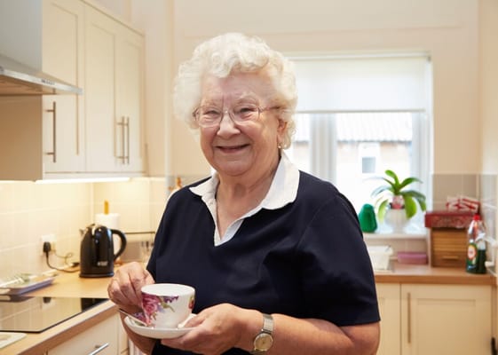 Senior woman smiling in a kitchen setting