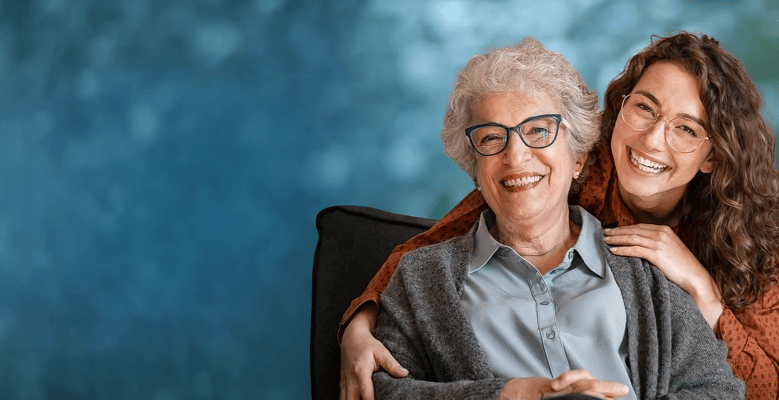 Senior woman and caregiver smiling together