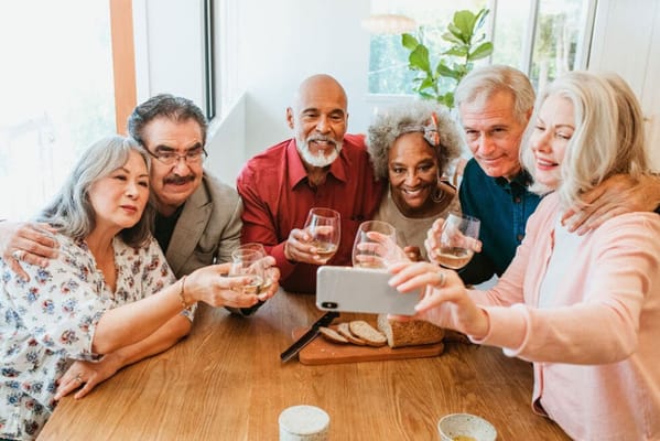 Residents celebrating with drinks at a dining table