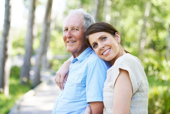 Senior man and caregiver enjoying time outdoors