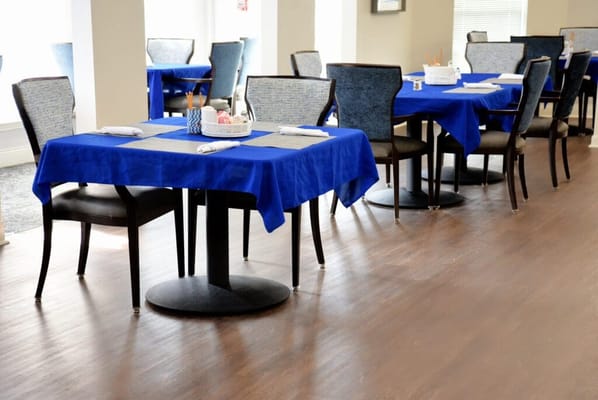 Dining area with blue tablecloths and chairs