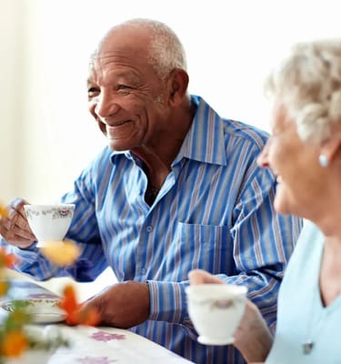 Residents enjoying tea together in a bright setting