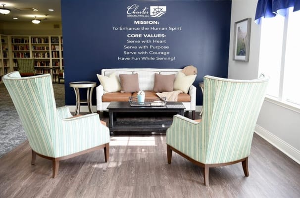 Cozily arranged lounge area with mission statement on the wall