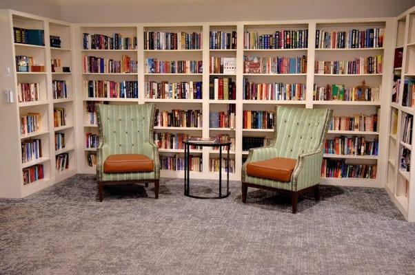 Cozy reading area with bookshelves and armchairs