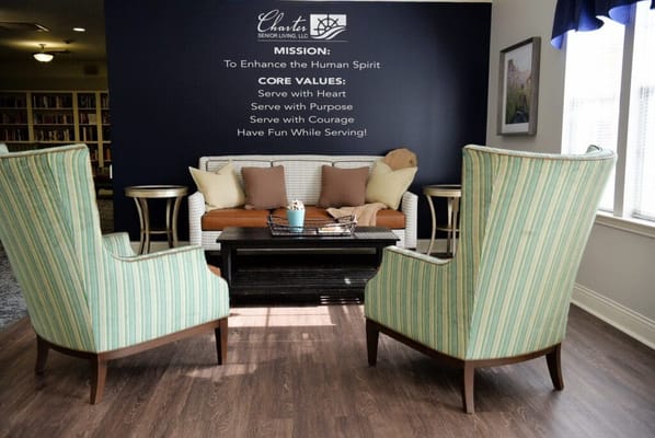 Comfortable seating area in a lobby with mission statement.